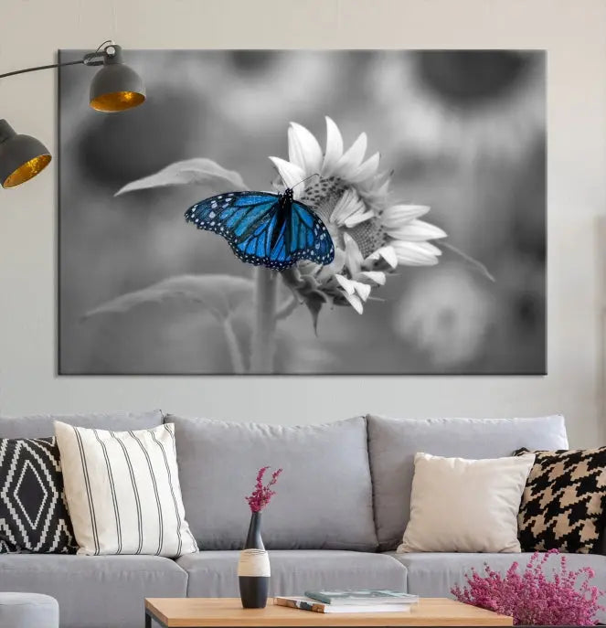 The modern living room showcases the Blue Butterfly Black and White Canvas Wall Art as a triptych. These museum-quality canvases, equipped with UV-protective coating and ready to hang, add both elegance and durability to the decor.