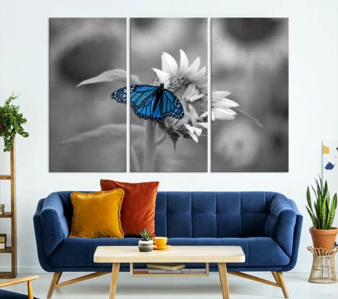 The modern living room showcases the Blue Butterfly Black and White Canvas Wall Art as a triptych. These museum-quality canvases, equipped with UV-protective coating and ready to hang, add both elegance and durability to the decor.