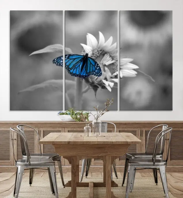 The modern living room showcases the Blue Butterfly Black and White Canvas Wall Art as a triptych. These museum-quality canvases, equipped with UV-protective coating and ready to hang, add both elegance and durability to the decor.