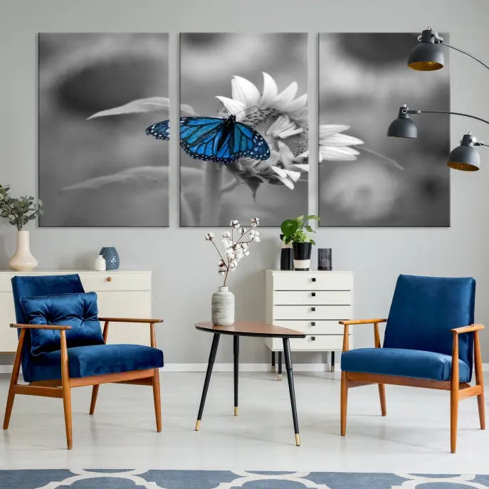 The modern living room showcases the Blue Butterfly Black and White Canvas Wall Art as a triptych. These museum-quality canvases, equipped with UV-protective coating and ready to hang, add both elegance and durability to the decor.