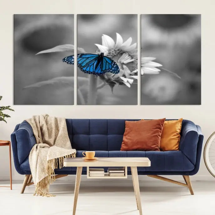 The modern living room showcases the Blue Butterfly Black and White Canvas Wall Art as a triptych. These museum-quality canvases, equipped with UV-protective coating and ready to hang, add both elegance and durability to the decor.