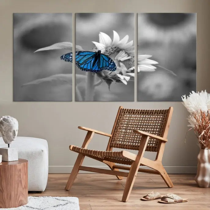 The modern living room showcases the Blue Butterfly Black and White Canvas Wall Art as a triptych. These museum-quality canvases, equipped with UV-protective coating and ready to hang, add both elegance and durability to the decor.