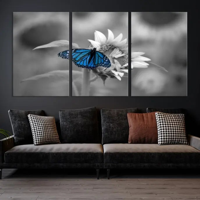 The modern living room showcases the Blue Butterfly Black and White Canvas Wall Art as a triptych. These museum-quality canvases, equipped with UV-protective coating and ready to hang, add both elegance and durability to the decor.