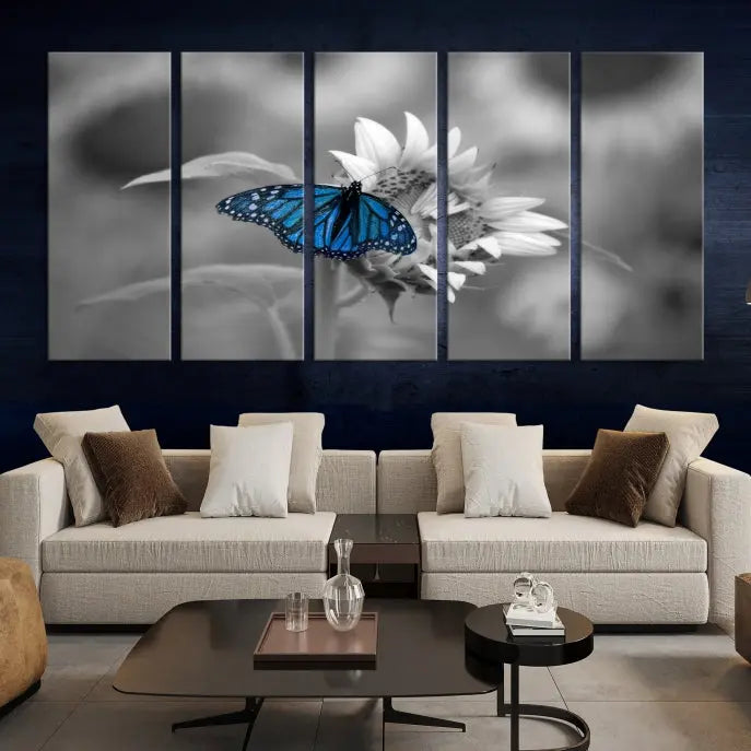 The modern living room showcases the Blue Butterfly Black and White Canvas Wall Art as a triptych. These museum-quality canvases, equipped with UV-protective coating and ready to hang, add both elegance and durability to the decor.