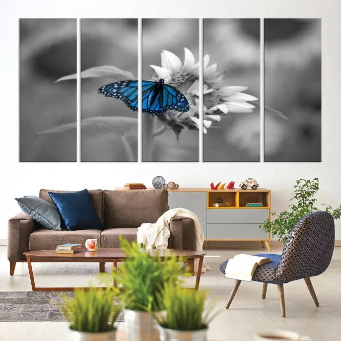 The modern living room showcases the Blue Butterfly Black and White Canvas Wall Art as a triptych. These museum-quality canvases, equipped with UV-protective coating and ready to hang, add both elegance and durability to the decor.