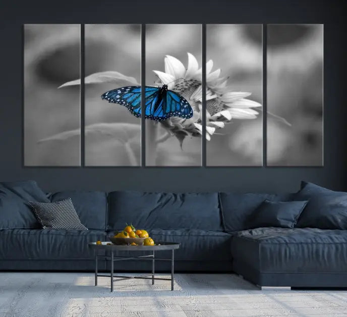 The modern living room showcases the Blue Butterfly Black and White Canvas Wall Art as a triptych. These museum-quality canvases, equipped with UV-protective coating and ready to hang, add both elegance and durability to the decor.