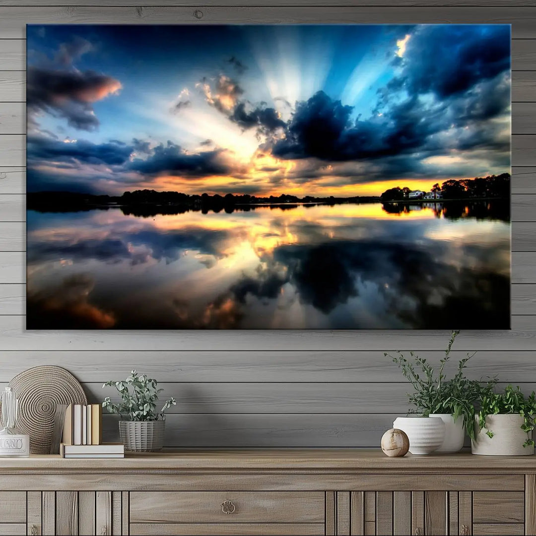 The "Blue Clouds and Sunshine Sunset Wall Art Canvas Print" perfectly captures a stunning sunset over a calm lake, where dramatic clouds and sunrays are beautifully reflected in the water. This museum-quality, ready-to-hang piece flawlessly preserves nature's breathtaking moment.