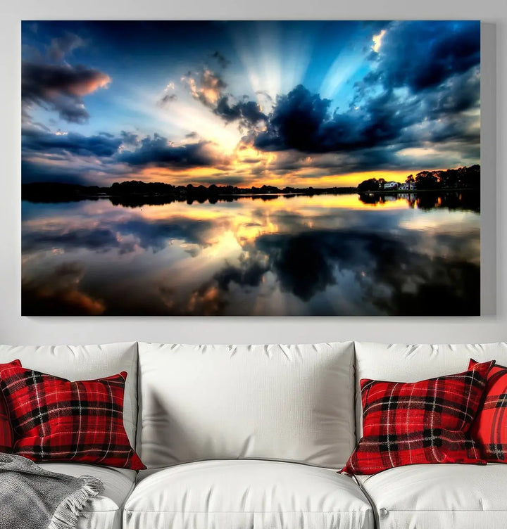 The "Blue Clouds and Sunshine Sunset Wall Art Canvas Print" perfectly captures a stunning sunset over a calm lake, where dramatic clouds and sunrays are beautifully reflected in the water. This museum-quality, ready-to-hang piece flawlessly preserves nature's breathtaking moment.