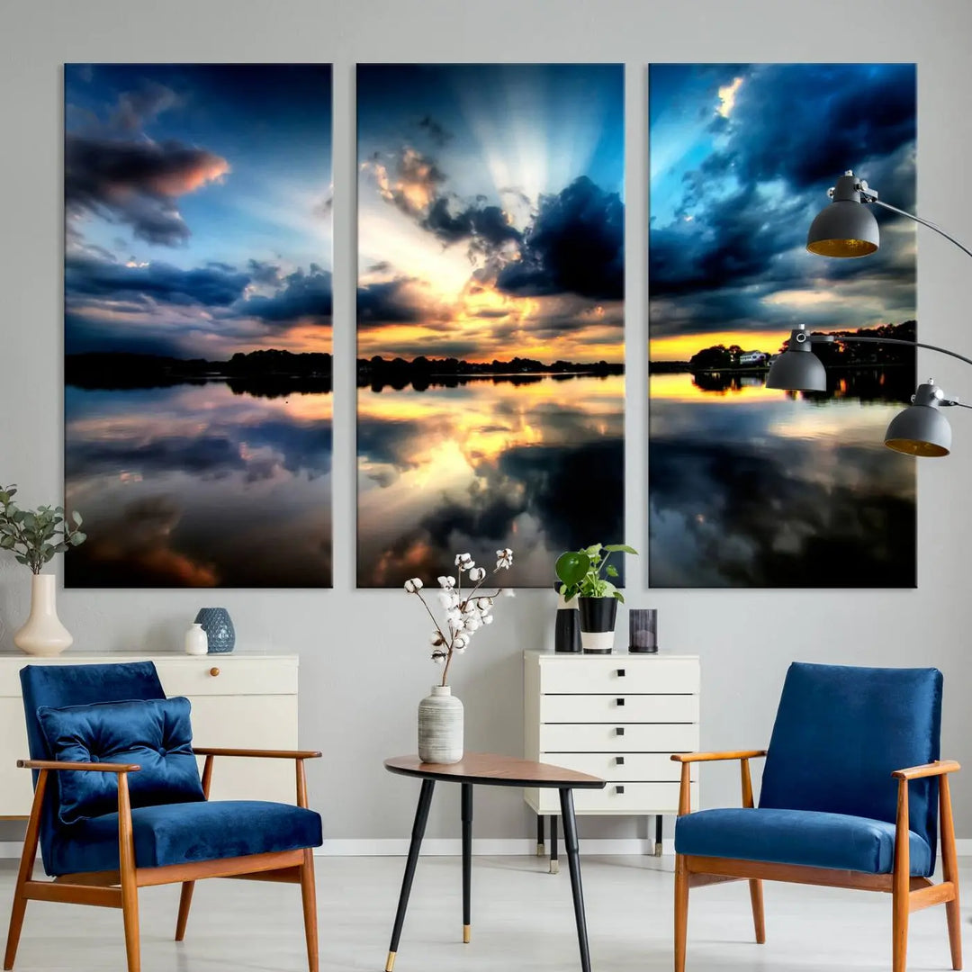 The "Blue Clouds and Sunshine Sunset Wall Art Canvas Print" perfectly captures a stunning sunset over a calm lake, where dramatic clouds and sunrays are beautifully reflected in the water. This museum-quality, ready-to-hang piece flawlessly preserves nature's breathtaking moment.