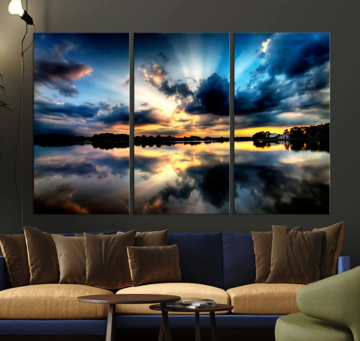 The "Blue Clouds and Sunshine Sunset Wall Art Canvas Print" perfectly captures a stunning sunset over a calm lake, where dramatic clouds and sunrays are beautifully reflected in the water. This museum-quality, ready-to-hang piece flawlessly preserves nature's breathtaking moment.