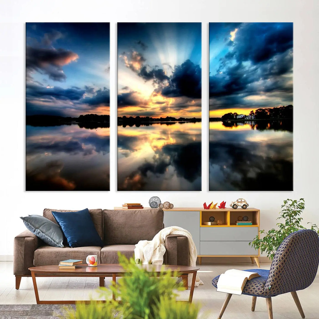 The "Blue Clouds and Sunshine Sunset Wall Art Canvas Print" perfectly captures a stunning sunset over a calm lake, where dramatic clouds and sunrays are beautifully reflected in the water. This museum-quality, ready-to-hang piece flawlessly preserves nature's breathtaking moment.