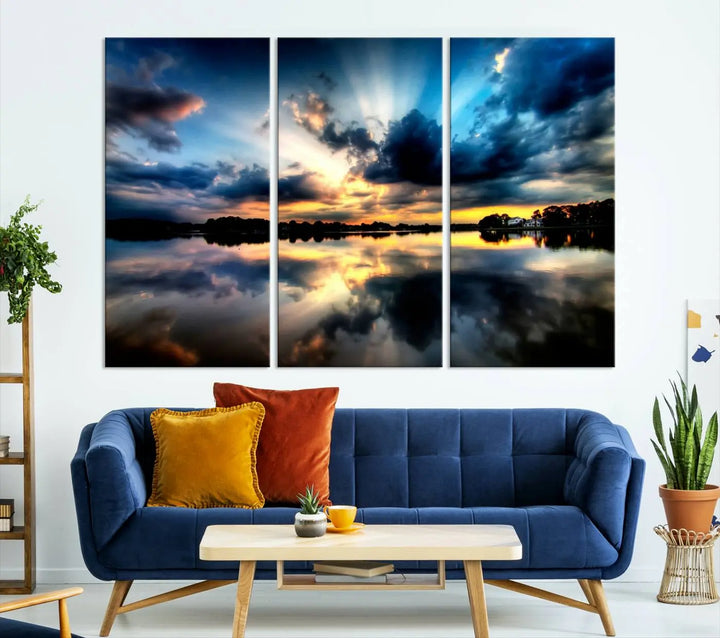 The "Blue Clouds and Sunshine Sunset Wall Art Canvas Print" perfectly captures a stunning sunset over a calm lake, where dramatic clouds and sunrays are beautifully reflected in the water. This museum-quality, ready-to-hang piece flawlessly preserves nature's breathtaking moment.