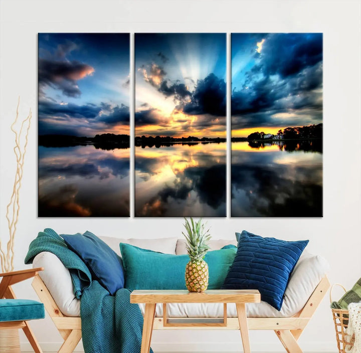 The "Blue Clouds and Sunshine Sunset Wall Art Canvas Print" perfectly captures a stunning sunset over a calm lake, where dramatic clouds and sunrays are beautifully reflected in the water. This museum-quality, ready-to-hang piece flawlessly preserves nature's breathtaking moment.