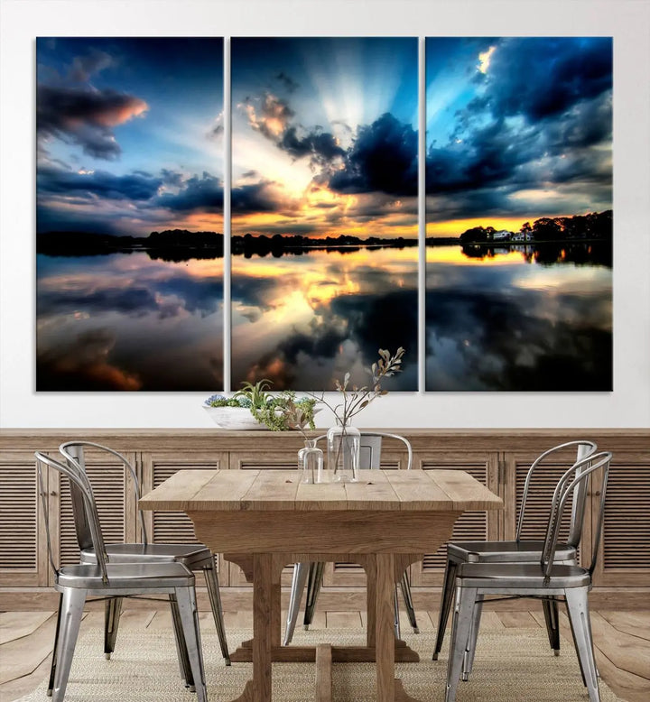 The "Blue Clouds and Sunshine Sunset Wall Art Canvas Print" perfectly captures a stunning sunset over a calm lake, where dramatic clouds and sunrays are beautifully reflected in the water. This museum-quality, ready-to-hang piece flawlessly preserves nature's breathtaking moment.