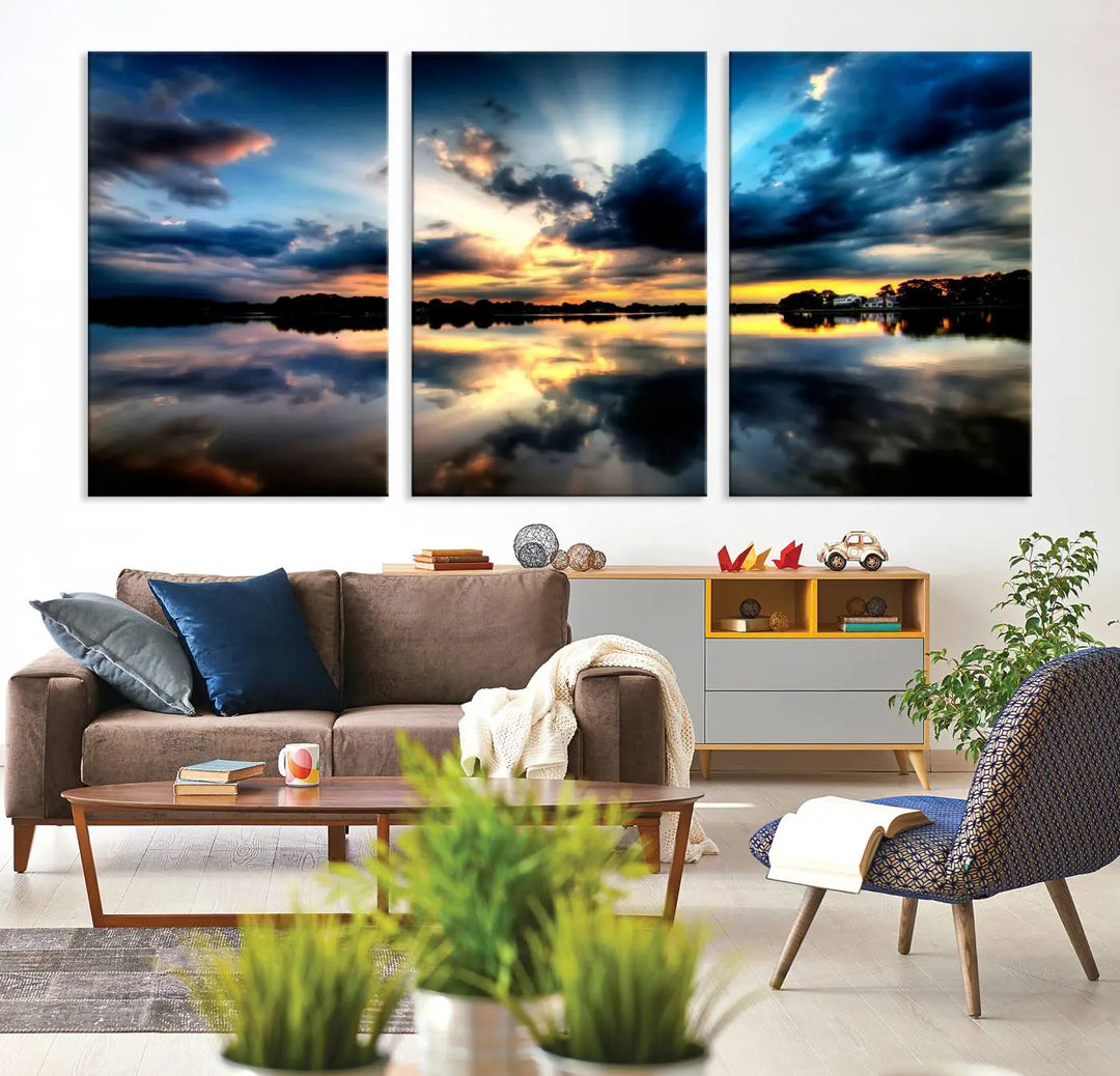 The "Blue Clouds and Sunshine Sunset Wall Art Canvas Print" perfectly captures a stunning sunset over a calm lake, where dramatic clouds and sunrays are beautifully reflected in the water. This museum-quality, ready-to-hang piece flawlessly preserves nature's breathtaking moment.