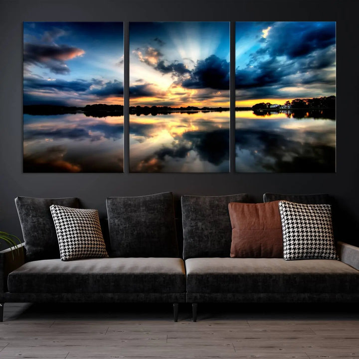 The "Blue Clouds and Sunshine Sunset Wall Art Canvas Print" perfectly captures a stunning sunset over a calm lake, where dramatic clouds and sunrays are beautifully reflected in the water. This museum-quality, ready-to-hang piece flawlessly preserves nature's breathtaking moment.