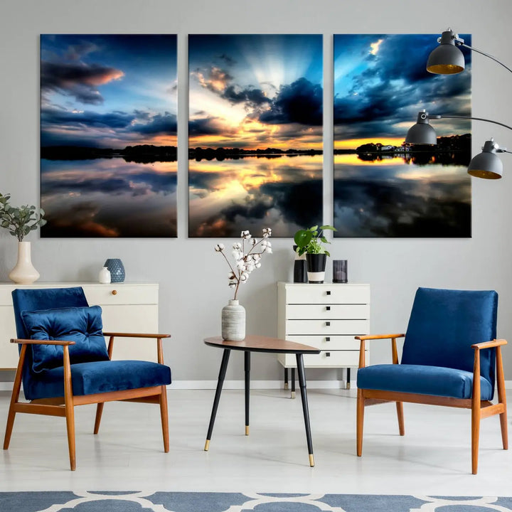 The "Blue Clouds and Sunshine Sunset Wall Art Canvas Print" perfectly captures a stunning sunset over a calm lake, where dramatic clouds and sunrays are beautifully reflected in the water. This museum-quality, ready-to-hang piece flawlessly preserves nature's breathtaking moment.