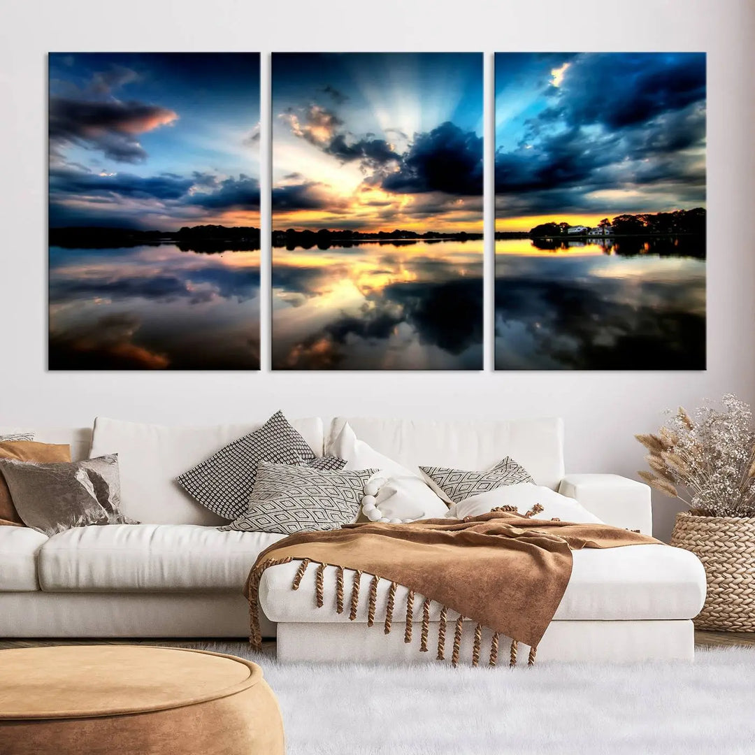 The "Blue Clouds and Sunshine Sunset Wall Art Canvas Print" perfectly captures a stunning sunset over a calm lake, where dramatic clouds and sunrays are beautifully reflected in the water. This museum-quality, ready-to-hang piece flawlessly preserves nature's breathtaking moment.