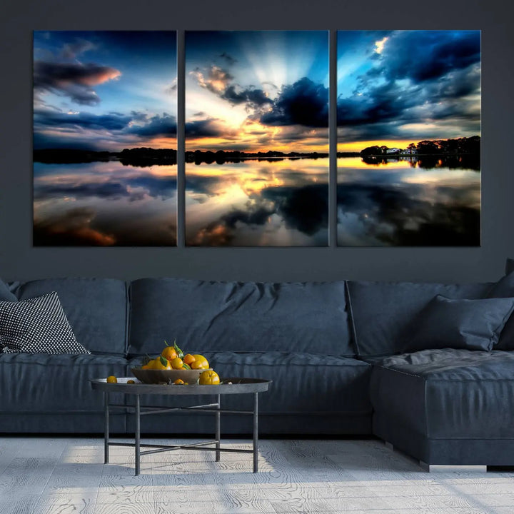 The "Blue Clouds and Sunshine Sunset Wall Art Canvas Print" perfectly captures a stunning sunset over a calm lake, where dramatic clouds and sunrays are beautifully reflected in the water. This museum-quality, ready-to-hang piece flawlessly preserves nature's breathtaking moment.