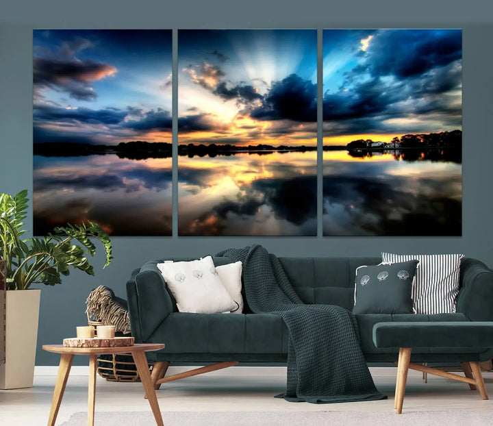 The "Blue Clouds and Sunshine Sunset Wall Art Canvas Print" perfectly captures a stunning sunset over a calm lake, where dramatic clouds and sunrays are beautifully reflected in the water. This museum-quality, ready-to-hang piece flawlessly preserves nature's breathtaking moment.