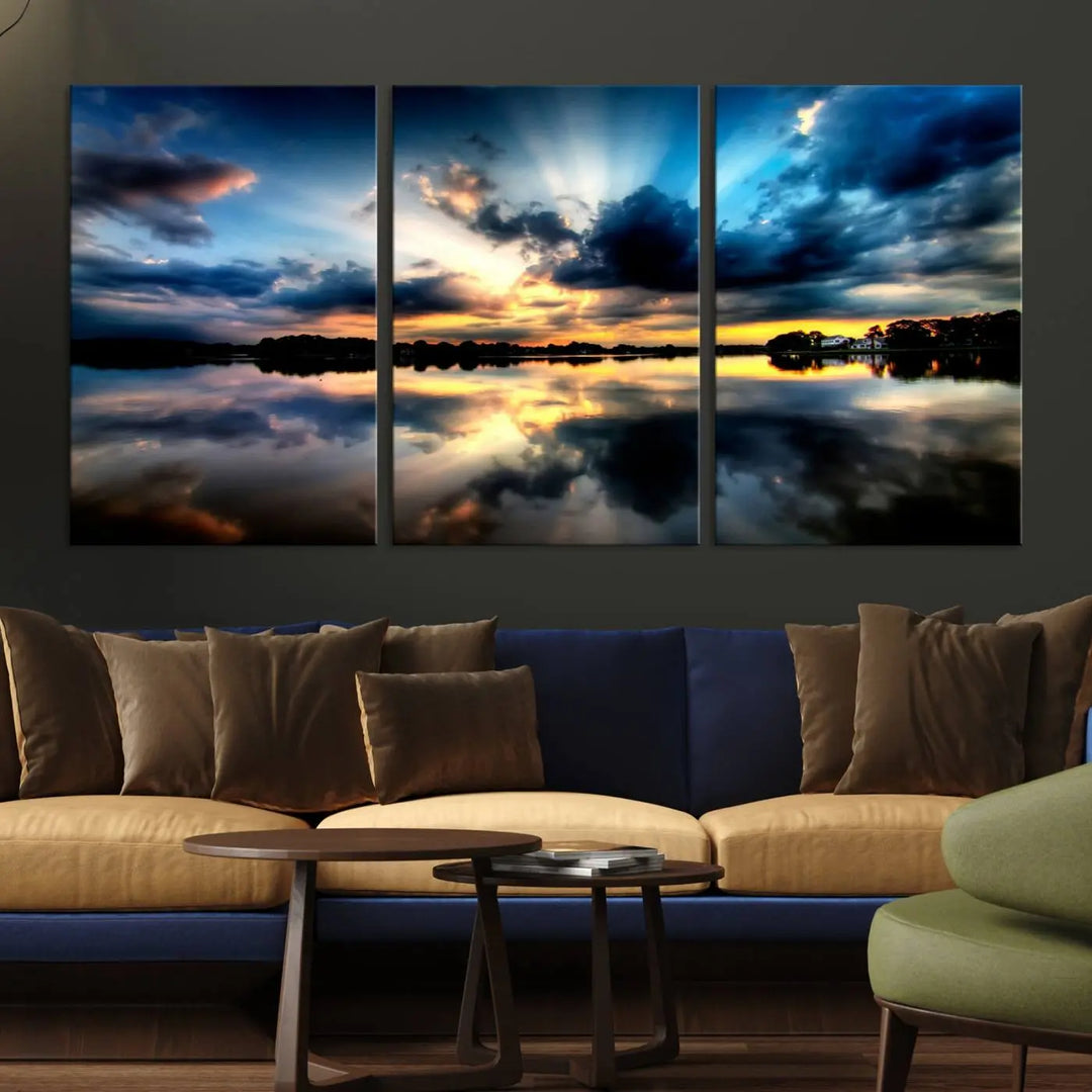 The "Blue Clouds and Sunshine Sunset Wall Art Canvas Print" perfectly captures a stunning sunset over a calm lake, where dramatic clouds and sunrays are beautifully reflected in the water. This museum-quality, ready-to-hang piece flawlessly preserves nature's breathtaking moment.