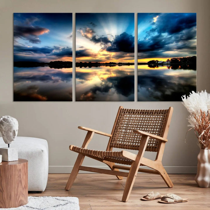 The "Blue Clouds and Sunshine Sunset Wall Art Canvas Print" perfectly captures a stunning sunset over a calm lake, where dramatic clouds and sunrays are beautifully reflected in the water. This museum-quality, ready-to-hang piece flawlessly preserves nature's breathtaking moment.