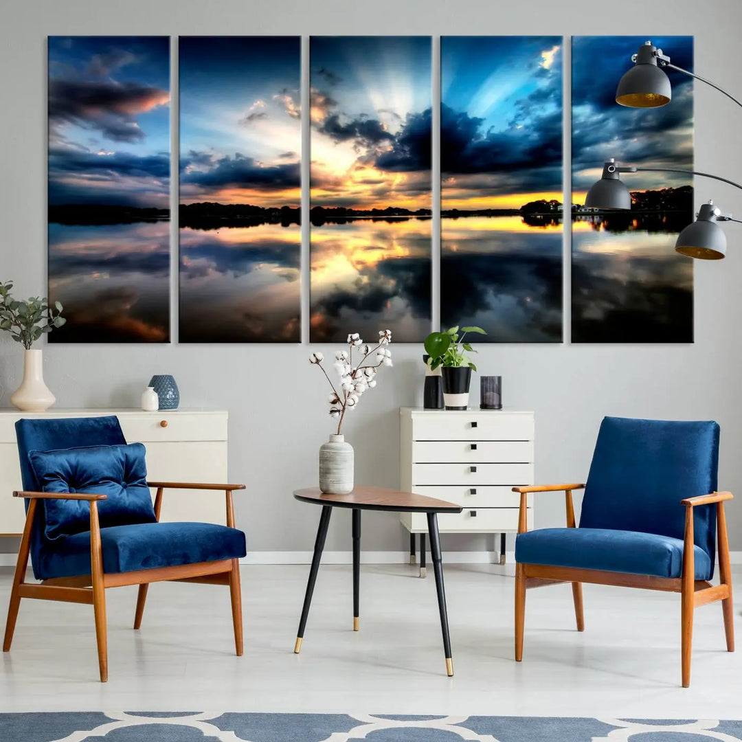 The "Blue Clouds and Sunshine Sunset Wall Art Canvas Print" perfectly captures a stunning sunset over a calm lake, where dramatic clouds and sunrays are beautifully reflected in the water. This museum-quality, ready-to-hang piece flawlessly preserves nature's breathtaking moment.