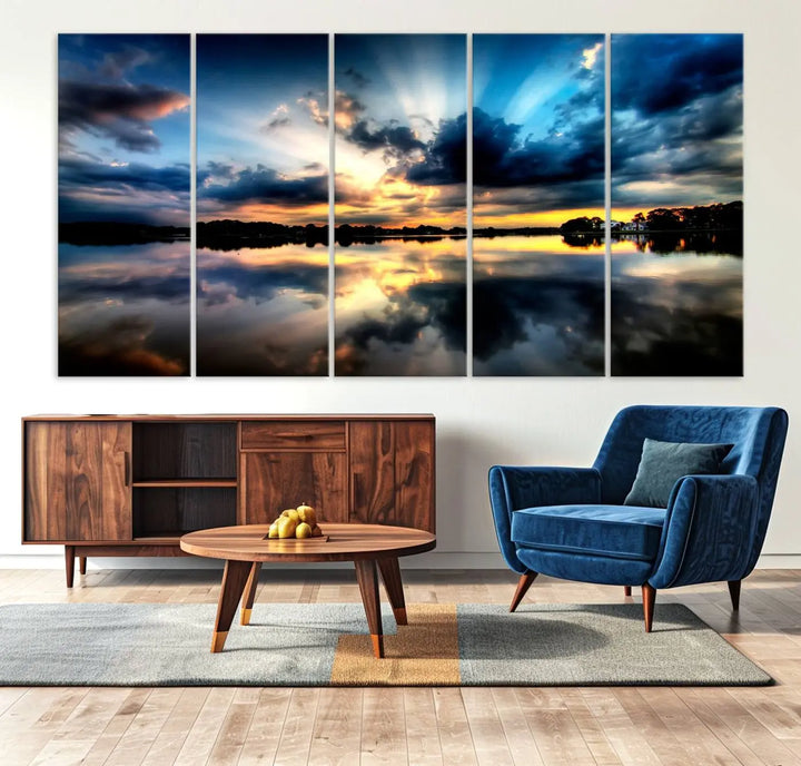 The "Blue Clouds and Sunshine Sunset Wall Art Canvas Print" perfectly captures a stunning sunset over a calm lake, where dramatic clouds and sunrays are beautifully reflected in the water. This museum-quality, ready-to-hang piece flawlessly preserves nature's breathtaking moment.