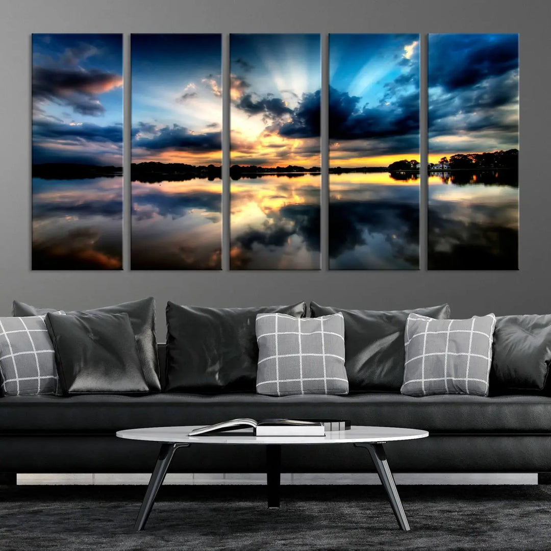 The "Blue Clouds and Sunshine Sunset Wall Art Canvas Print" perfectly captures a stunning sunset over a calm lake, where dramatic clouds and sunrays are beautifully reflected in the water. This museum-quality, ready-to-hang piece flawlessly preserves nature's breathtaking moment.