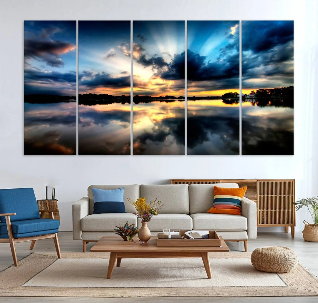 The "Blue Clouds and Sunshine Sunset Wall Art Canvas Print" perfectly captures a stunning sunset over a calm lake, where dramatic clouds and sunrays are beautifully reflected in the water. This museum-quality, ready-to-hang piece flawlessly preserves nature's breathtaking moment.