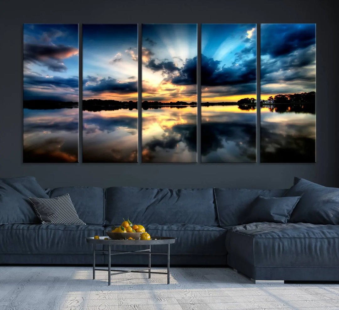 The "Blue Clouds and Sunshine Sunset Wall Art Canvas Print" perfectly captures a stunning sunset over a calm lake, where dramatic clouds and sunrays are beautifully reflected in the water. This museum-quality, ready-to-hang piece flawlessly preserves nature's breathtaking moment.