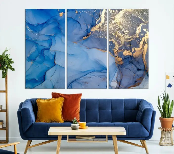 Modern living room featuring the Blue Gold Marble Fluid Canvas Wall Art that showcases three-panel abstract designs in blue and gold on museum-quality canvas. These art pieces are professionally hand-assembled for an exquisite finish.