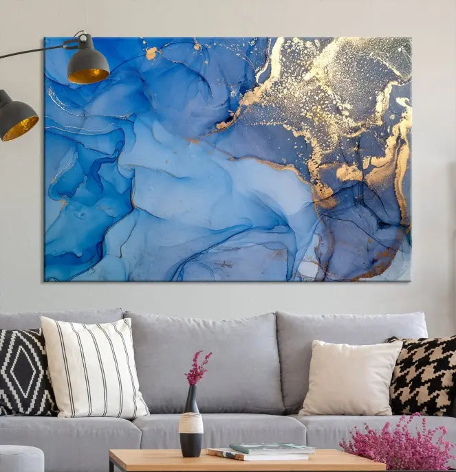 Modern living room featuring the Blue Gold Marble Fluid Canvas Wall Art that showcases three-panel abstract designs in blue and gold on museum-quality canvas. These art pieces are professionally hand-assembled for an exquisite finish.