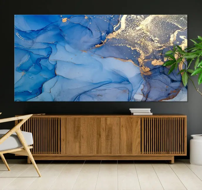 Modern living room featuring the Blue Gold Marble Fluid Canvas Wall Art that showcases three-panel abstract designs in blue and gold on museum-quality canvas. These art pieces are professionally hand-assembled for an exquisite finish.