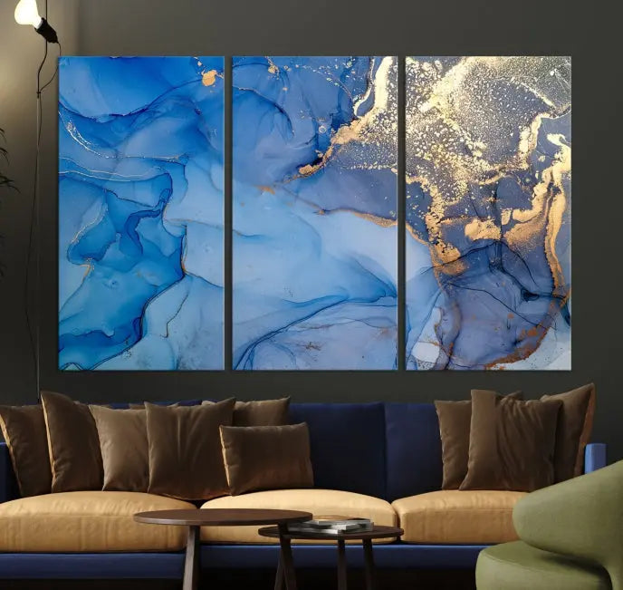 Modern living room featuring the Blue Gold Marble Fluid Canvas Wall Art that showcases three-panel abstract designs in blue and gold on museum-quality canvas. These art pieces are professionally hand-assembled for an exquisite finish.