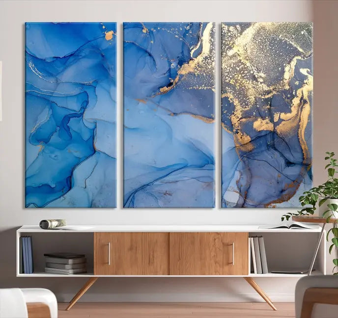 Modern living room featuring the Blue Gold Marble Fluid Canvas Wall Art that showcases three-panel abstract designs in blue and gold on museum-quality canvas. These art pieces are professionally hand-assembled for an exquisite finish.