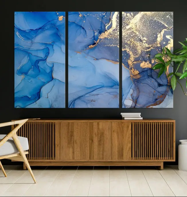 Modern living room featuring the Blue Gold Marble Fluid Canvas Wall Art that showcases three-panel abstract designs in blue and gold on museum-quality canvas. These art pieces are professionally hand-assembled for an exquisite finish.