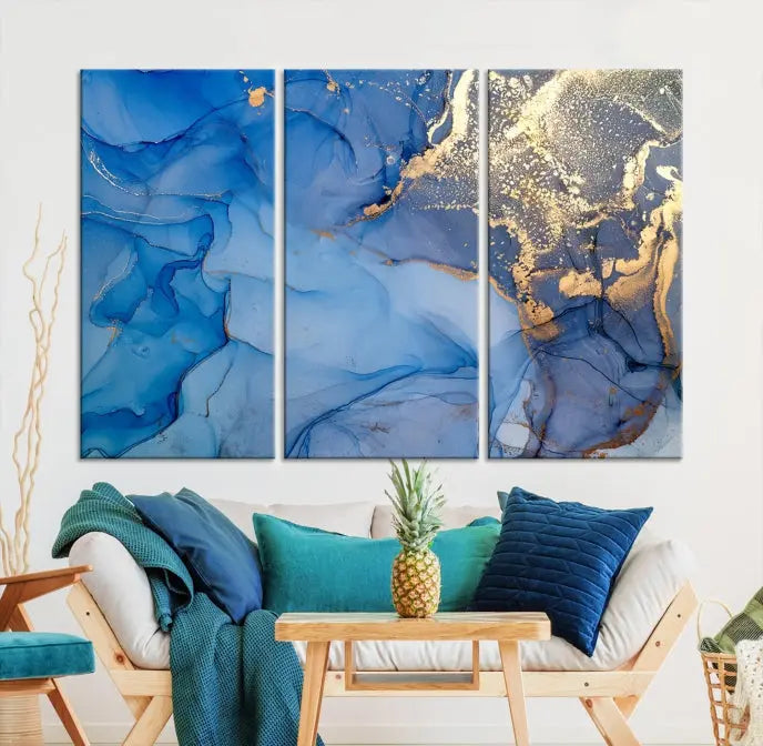 Modern living room featuring the Blue Gold Marble Fluid Canvas Wall Art that showcases three-panel abstract designs in blue and gold on museum-quality canvas. These art pieces are professionally hand-assembled for an exquisite finish.