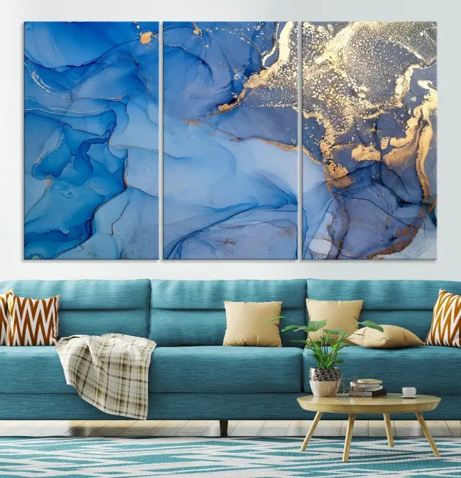 Modern living room featuring the Blue Gold Marble Fluid Canvas Wall Art that showcases three-panel abstract designs in blue and gold on museum-quality canvas. These art pieces are professionally hand-assembled for an exquisite finish.