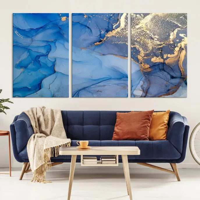 Modern living room featuring the Blue Gold Marble Fluid Canvas Wall Art that showcases three-panel abstract designs in blue and gold on museum-quality canvas. These art pieces are professionally hand-assembled for an exquisite finish.