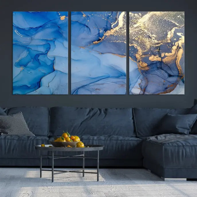 Modern living room featuring the Blue Gold Marble Fluid Canvas Wall Art that showcases three-panel abstract designs in blue and gold on museum-quality canvas. These art pieces are professionally hand-assembled for an exquisite finish.