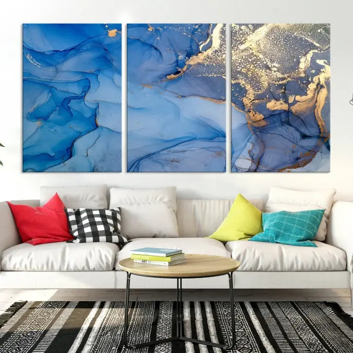 Modern living room featuring the Blue Gold Marble Fluid Canvas Wall Art that showcases three-panel abstract designs in blue and gold on museum-quality canvas. These art pieces are professionally hand-assembled for an exquisite finish.