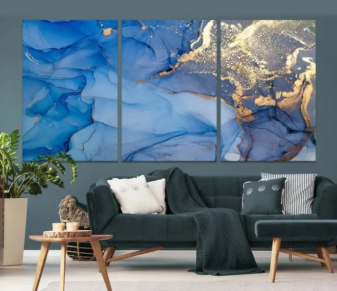 Modern living room featuring the Blue Gold Marble Fluid Canvas Wall Art that showcases three-panel abstract designs in blue and gold on museum-quality canvas. These art pieces are professionally hand-assembled for an exquisite finish.