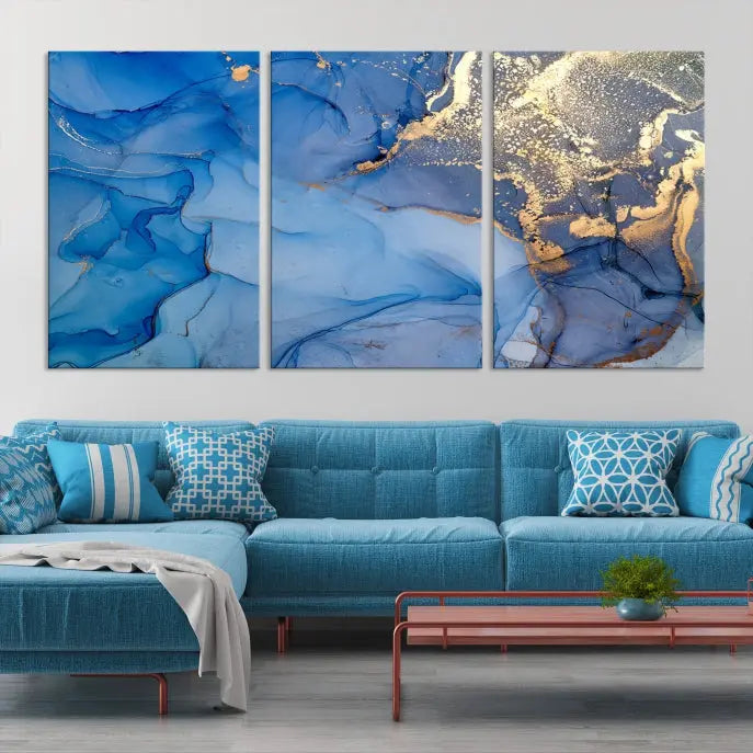 Modern living room featuring the Blue Gold Marble Fluid Canvas Wall Art that showcases three-panel abstract designs in blue and gold on museum-quality canvas. These art pieces are professionally hand-assembled for an exquisite finish.