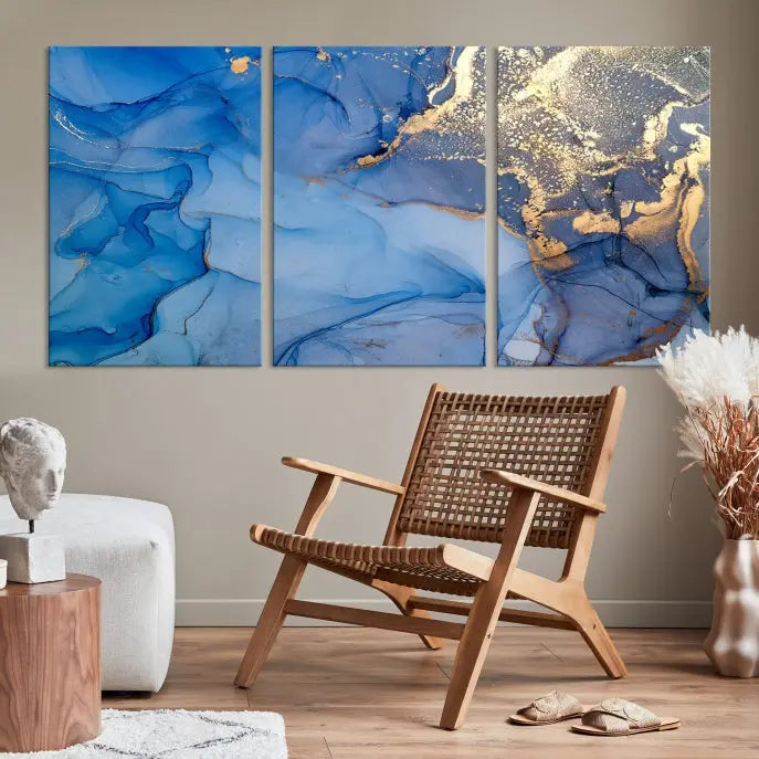 Modern living room featuring the Blue Gold Marble Fluid Canvas Wall Art that showcases three-panel abstract designs in blue and gold on museum-quality canvas. These art pieces are professionally hand-assembled for an exquisite finish.