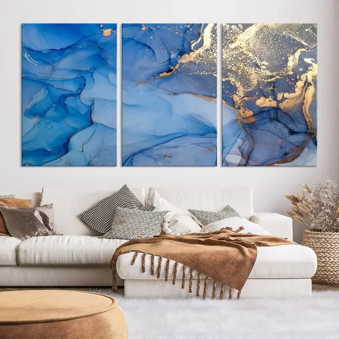 Modern living room featuring the Blue Gold Marble Fluid Canvas Wall Art that showcases three-panel abstract designs in blue and gold on museum-quality canvas. These art pieces are professionally hand-assembled for an exquisite finish.