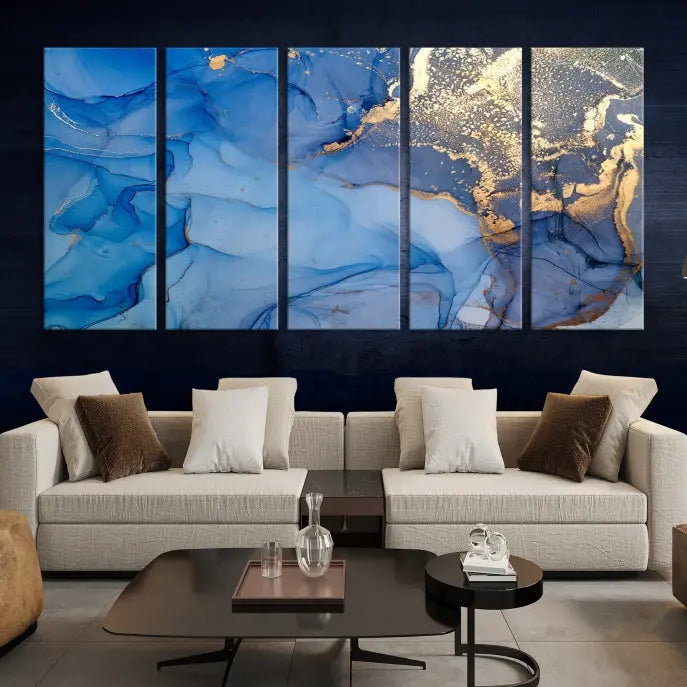 Modern living room featuring the Blue Gold Marble Fluid Canvas Wall Art that showcases three-panel abstract designs in blue and gold on museum-quality canvas. These art pieces are professionally hand-assembled for an exquisite finish.