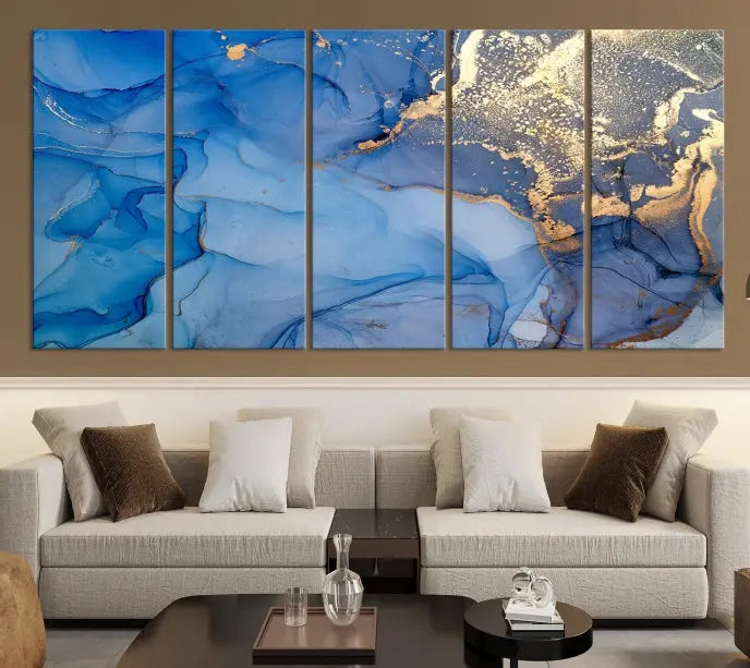 Modern living room featuring the Blue Gold Marble Fluid Canvas Wall Art that showcases three-panel abstract designs in blue and gold on museum-quality canvas. These art pieces are professionally hand-assembled for an exquisite finish.