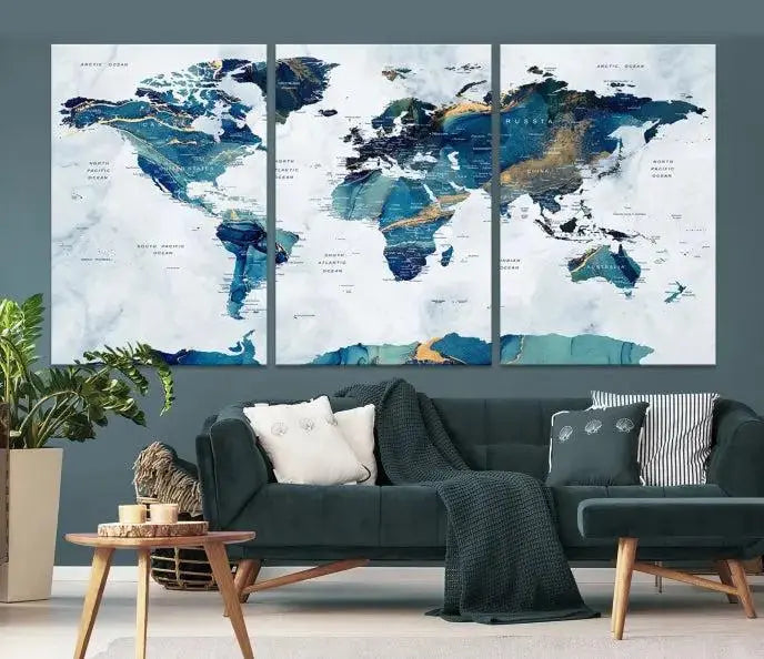 The modern living room showcases the Blue Green World Map Wall Art Canvas Print, a captivating three-panel artwork crafted on museum-quality canvases with a UV-protective coating.