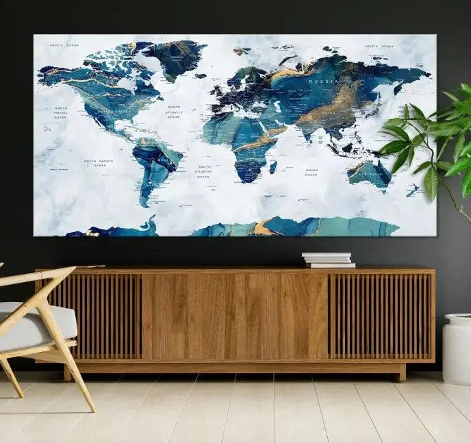 The modern living room showcases the Blue Green World Map Wall Art Canvas Print, a captivating three-panel artwork crafted on museum-quality canvases with a UV-protective coating.